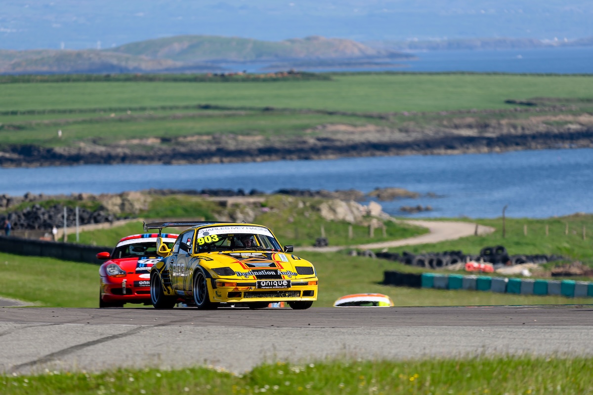 VANHAUEN RACING at Anglesey 2023 - Ahead of a rival Porsche, with the Anglesey coastline behind. © Jonathan Elsey Motorsport Photography 2023