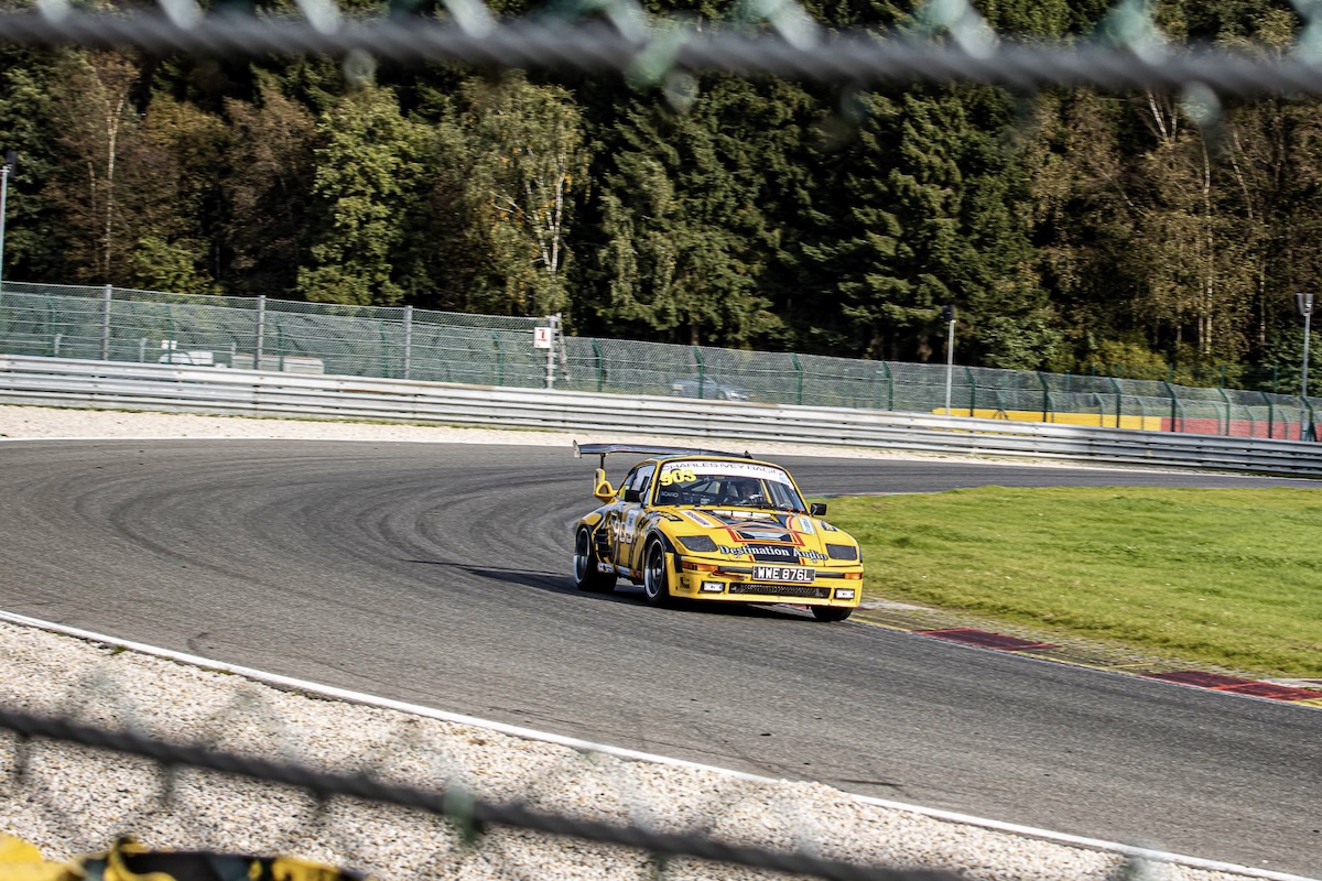 Fantastic framing through the safety fencing — catching the 903 mid-corner in an epic trackside shot.